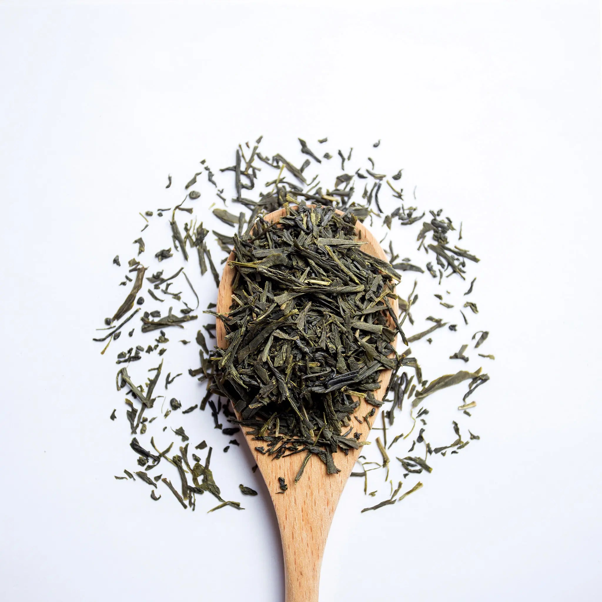 A wooden spoon with loose leaf tea