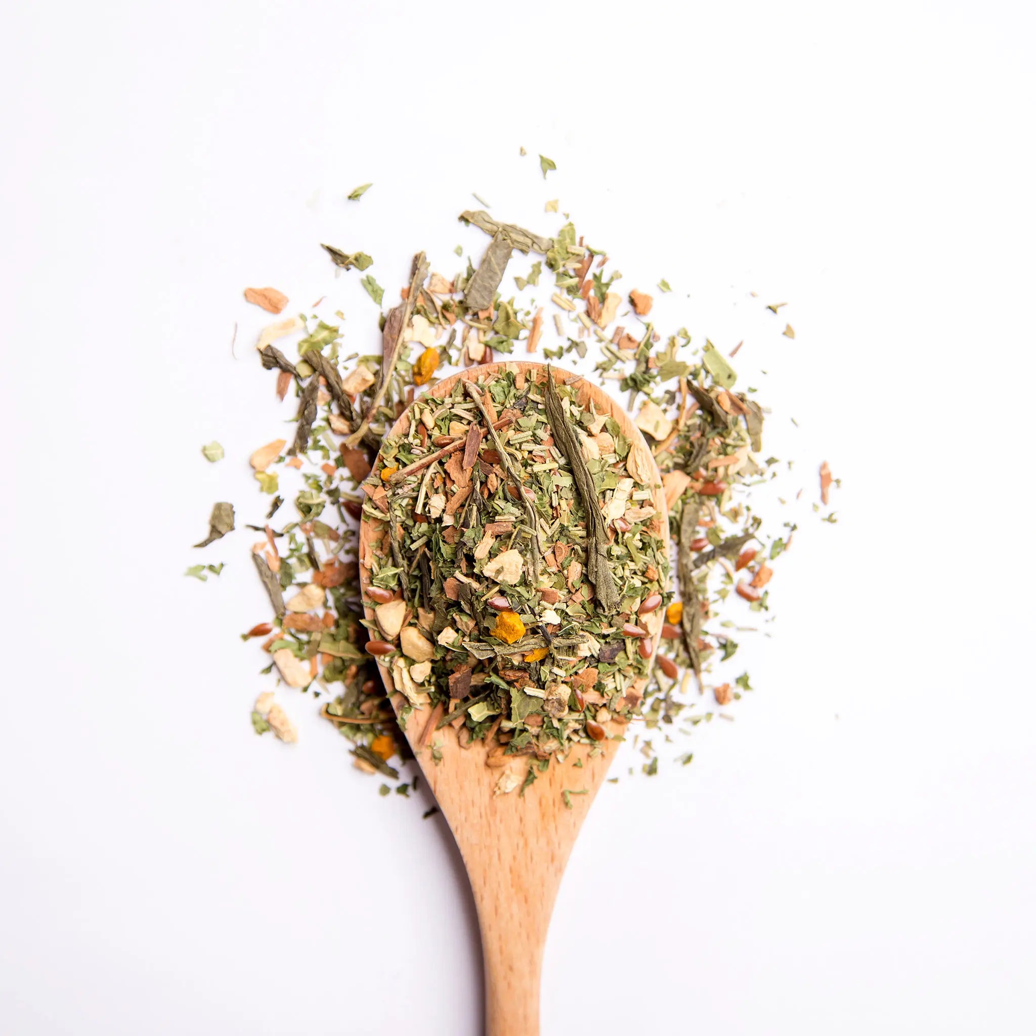 A wooden spoon with loose leaf tea