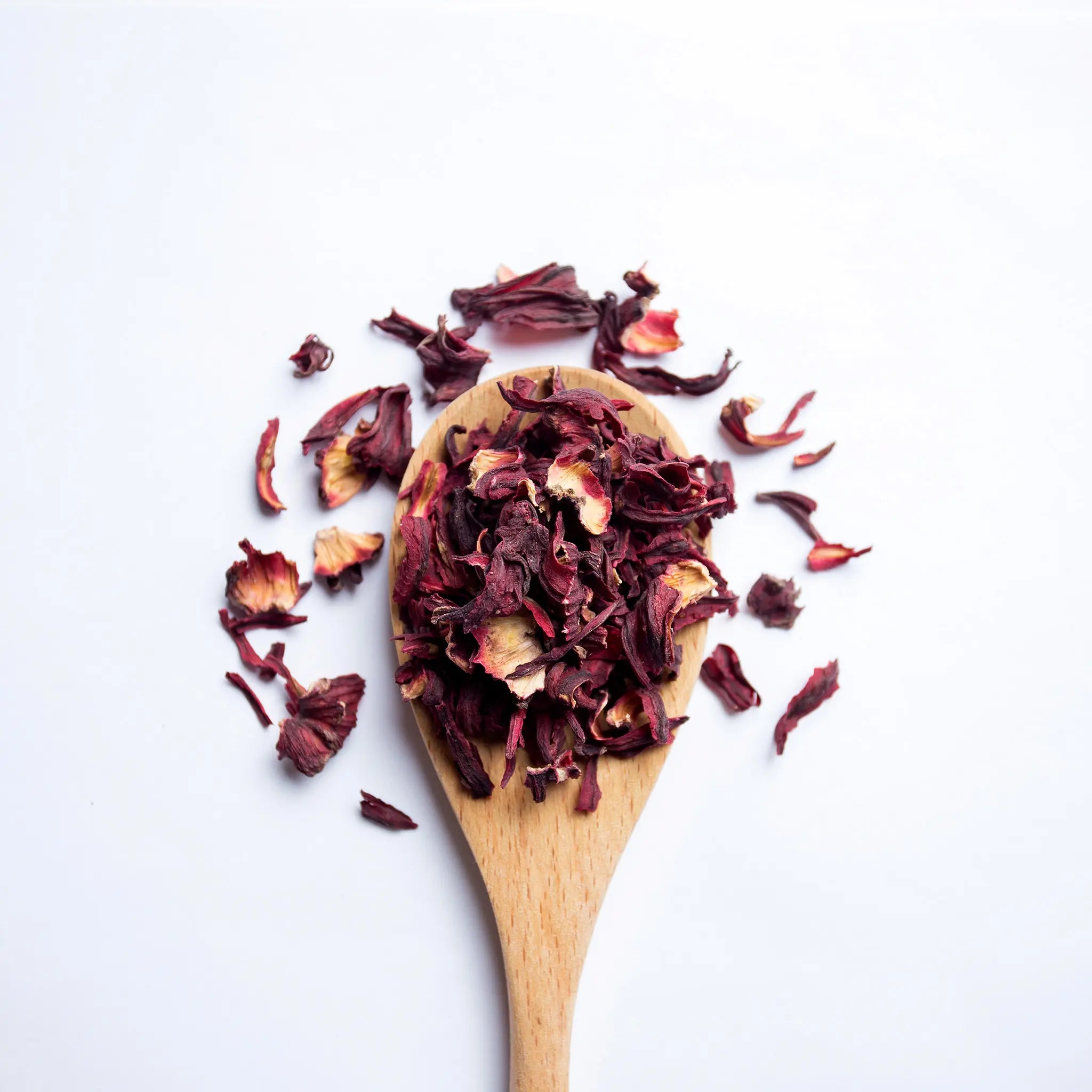 A wooden spoon with loose leaf tea